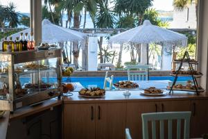 a buffet with food on a counter in a resort at Saranda Hotel in Sarandë