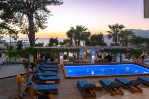 a pool at a hotel with blue lounge chairs at Saranda Hotel in Sarandë
