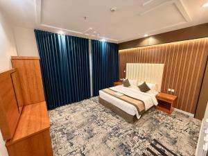a hotel room with a bed and a television at Milestone Rise Jeddah in Jeddah +74 photos