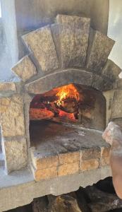 a brick oven with a fire in it at Maison Carrée Andilana in Andilana