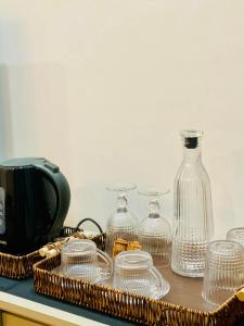 a tray of glass dishes and a bottle on a counter at D'Arte Suite in Tal-Liedna