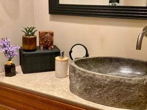 a bathroom sink with a granite counter top with a sink at D'Arte Suite in Tal-Liedna