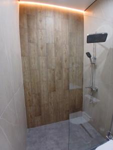 a shower with a glass door in a bathroom at Park Avenue Hotel in Taraz