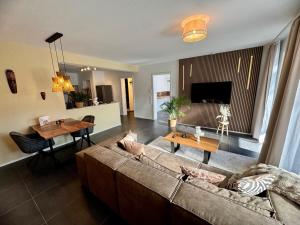 a living room with a couch and a table at Zuri Suite in Rittersdorf