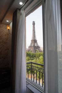 a window with a view of the eiffel tower at Eifel Heights Apartments in Lahore
