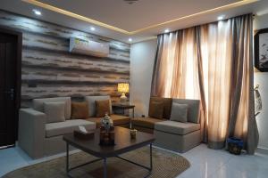 a living room with a couch and a table at Eifel Heights Apartments in Lahore