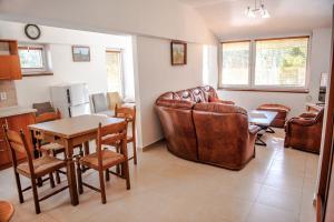 a living room with a couch and a table and chairs at MEANDER THERMAL & SKI REZORT ORAVICE in Oravice +47 photos
