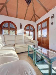 a living room with a couch and a glass table at Torre Santo Dios in Iznájar +80 photos