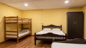 a bedroom with a bunk bed and a bunk ladder at SPKA Jungle Resort in Vālpārai