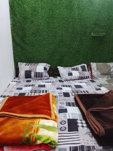 a bed with a comforter and pillows on it at Dev Giri Guest House in Phata