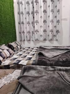 a room with a bed in front of a curtain at Dev Giri Guest House in Phata