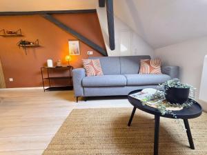 a living room with a couch and a table at Le cocon du Florival - Box à vélo - Guebwiller in Guebwiller