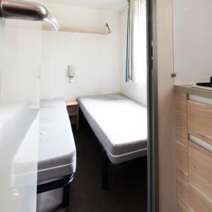 a small room with a bed and a desk at Camping Het Veen in Brecht