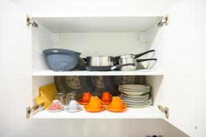 a cupboard with dishes and pots and pans at ORIGINI - Dimora tra murgia e mare in Toritto