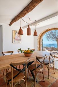 a dining room with a wooden table and chairs at Bastide Saint-Honorat in Grasse