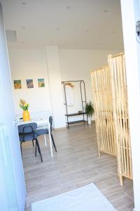 a dining room with a table and a chair at ORIGINI - Dimora tra murgia e mare in Toritto