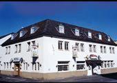 a large white building with a black roof at Hotel Concordia in Euskirchen