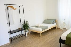 a bedroom with a bed and a side table at ORIGINI - Dimora tra murgia e mare in Toritto