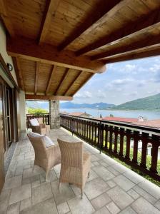 a patio with chairs and a view of the water at Casa Elisabeth in Sarnico