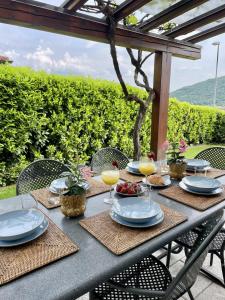 a table with plates of food and glasses of orange juice at Casa Elisabeth in Sarnico