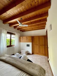 a bedroom with a large bed and wooden ceilings at Casa Elisabeth in Sarnico
