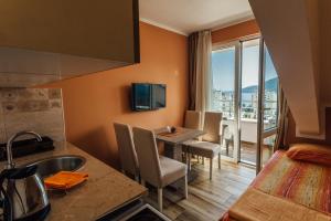 a room with a kitchen and a table with a view at Apartments Anastasija in Herceg-Novi