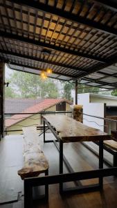 a large wooden table and bench on a patio at Villa W-5 Villa Private Pool Lembang, Bandung in Bandung