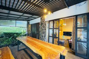 a large wooden bench in a room with windows at Villa W-5 Villa Private Pool Lembang, Bandung in Bandung