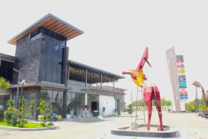 a statue in front of a building with a building at City Center Suites in Bhatinda