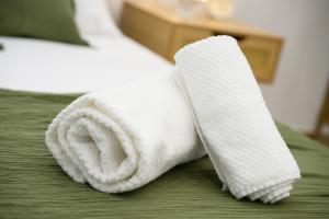 a white towel on top of a bed at ORIGINI - Dimora tra murgia e mare in Toritto