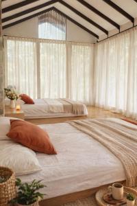 two beds in a room with white curtains at Villa W-5 Villa Private Pool Lembang, Bandung in Bandung +40 photos