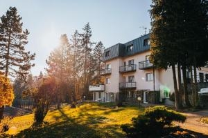 an apartment building in a park with trees at Penzion U Libuše Luleč in Lultsch
