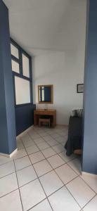 a living room with a tv and a tiled floor at Stella Hotel in Pefki