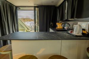 a kitchen with a black counter top in a caravan at Celesia SKy Water Andromeda in Sesto Calende +7 photos