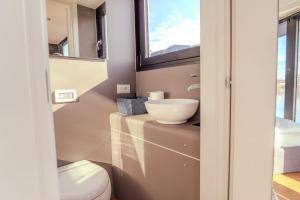 a bathroom with a sink and a toilet at Celesia SKy Water Andromeda in Sesto Calende