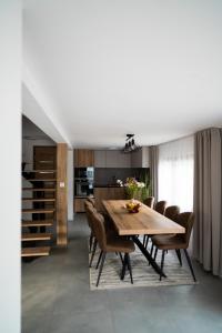 a kitchen and dining room with a wooden table and chairs at Chata Rosa in Námestovo