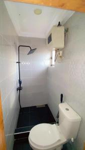 ein kleines Badezimmer mit Toilette und Dusche in der Unterkunft Plot1 Suits in Ibadan