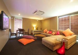 a living room with a couch and a table at Baan Asan in Taling Ngam Beach