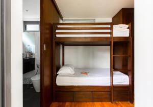 a bunk bed in a room with a bathroom at Baan Asan in Taling Ngam Beach +24 photos