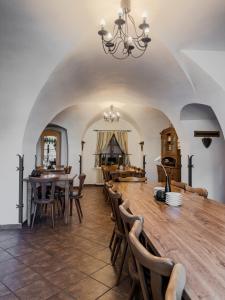 a dining room with a large wooden table and chairs at Hotel Rytířsko in Jamné