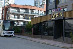 a bus parked in front of a building at Casa Ayris Boutique Hotel in Mersin
