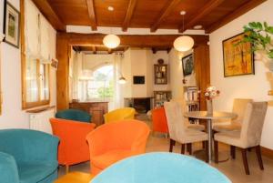 a dining room with colorful chairs and a table at Hotel Restaurant de charme La Lozerette - Proche Florac in Cocurès +26 photos