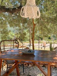 a wooden table with a chandelier hanging over it at Katerina's House in Volímai