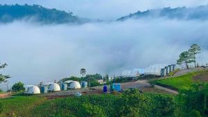 a row of portable toilets on a hill in the clouds at เขาเจ้าขา-เต็นท์กระโจมเขาค้อ โดมvip in Khao Kho +16 photos