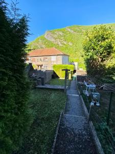 a view of a yard with a house and a hill at Gîte des Prés in Revin +7 photos