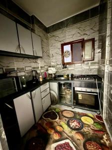a kitchen with a bunch of pizzas on the floor at Center Apartment in Aswan