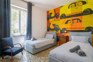 a bedroom with two beds and a painting on the wall at ComoVà in Maslianico