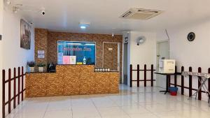 a lobby with a counter in the middle of a building at Collection O Malacca Formerly Lavender Inn in Malacca