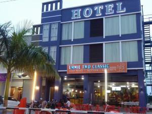 a blue hotel with a sign that reads wine two classic at Collection O Malacca Formerly Lavender Inn in Malacca