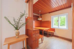 a room with a table and a vase with a plant at Cosy Vintage House Bled in Bled